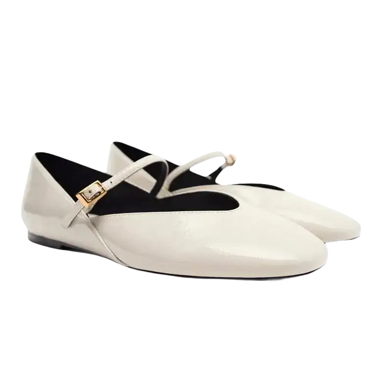 Pair of white patent leather Mary Jane flats.
