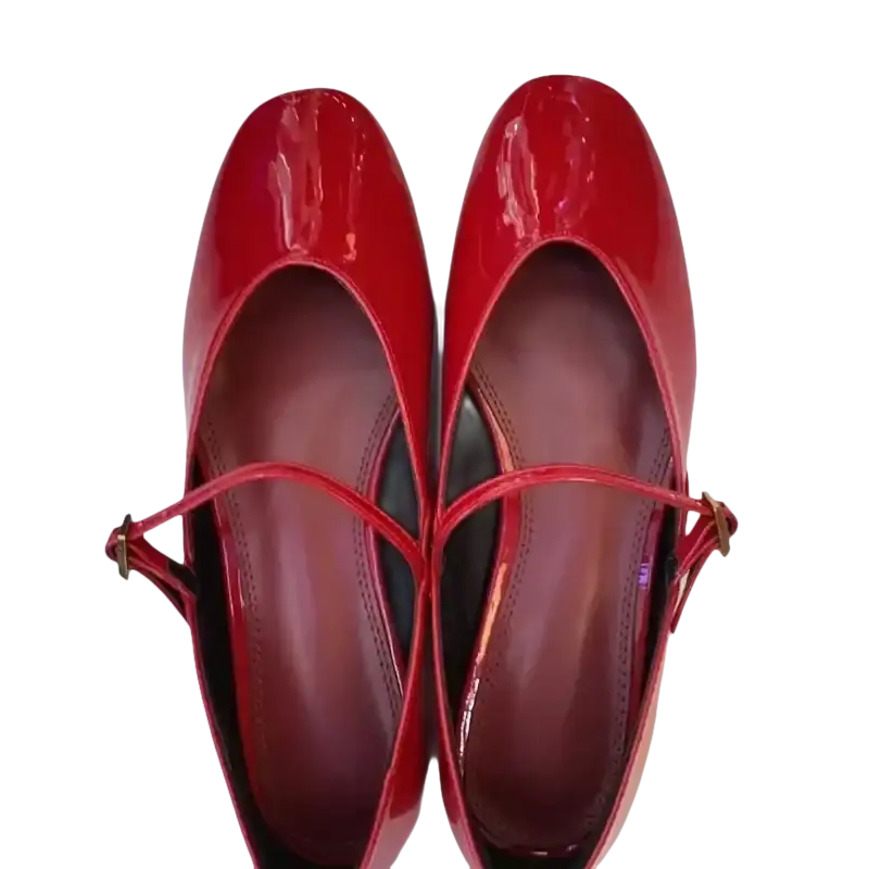 Pair of shiny red Mary Jane shoes.