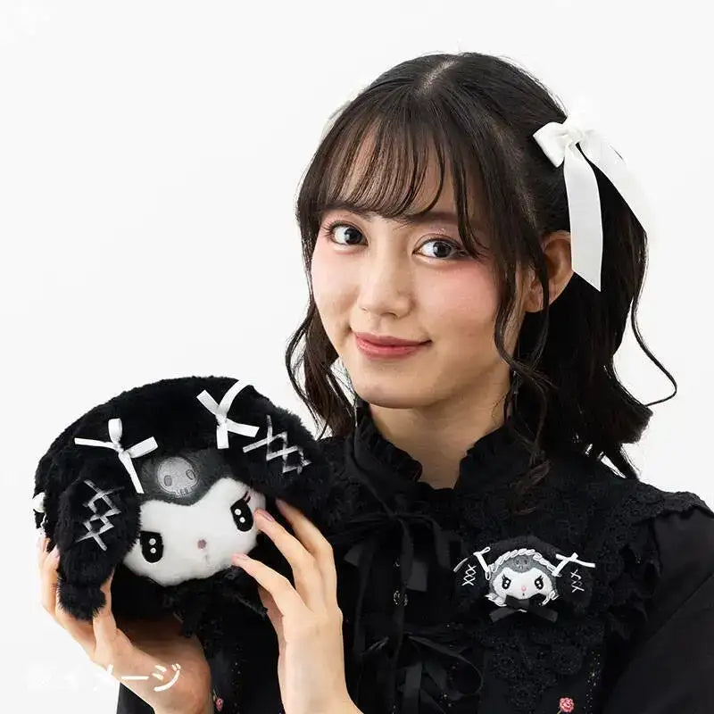 Young woman holding a Kuromi plush.