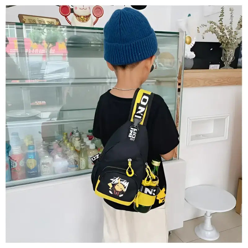 Black sling bag with yellow accents.