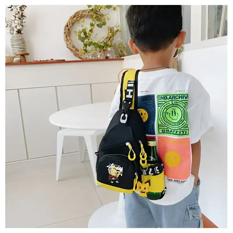 Child’s black sling backpack with cartoon characters.