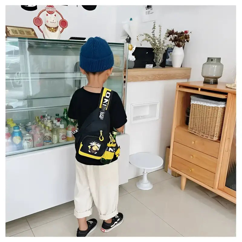 Child’s black and yellow sling bag.