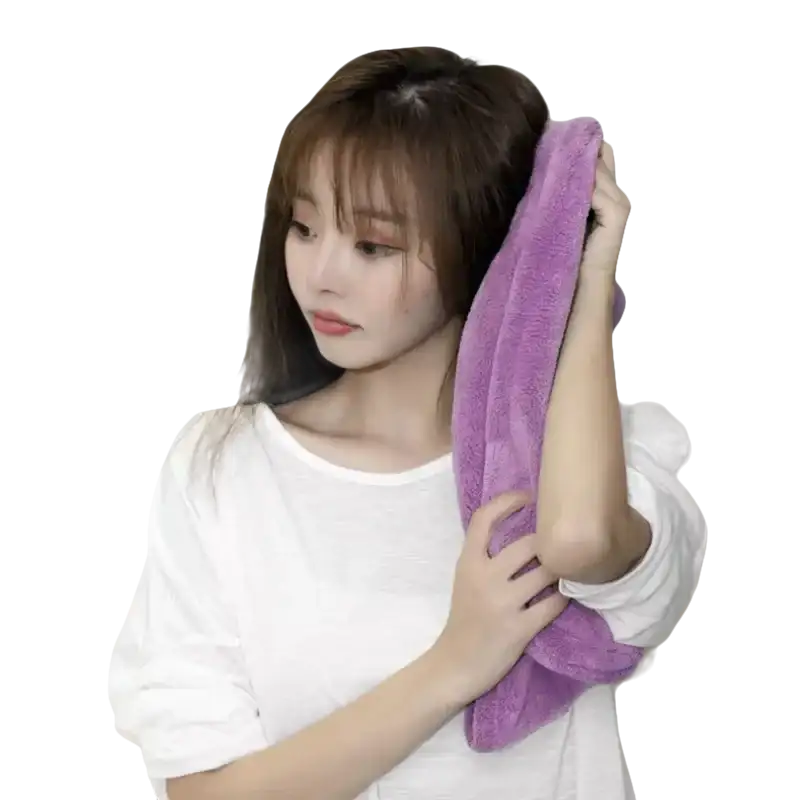 Woman drying hair with purple towel.