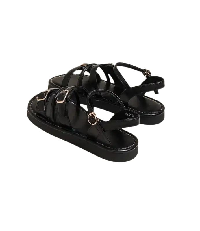 Black buckled platform sandals.