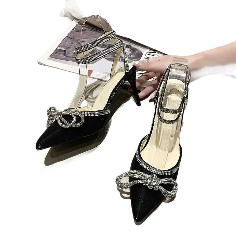 Black high-heeled shoes with rhinestone bows.