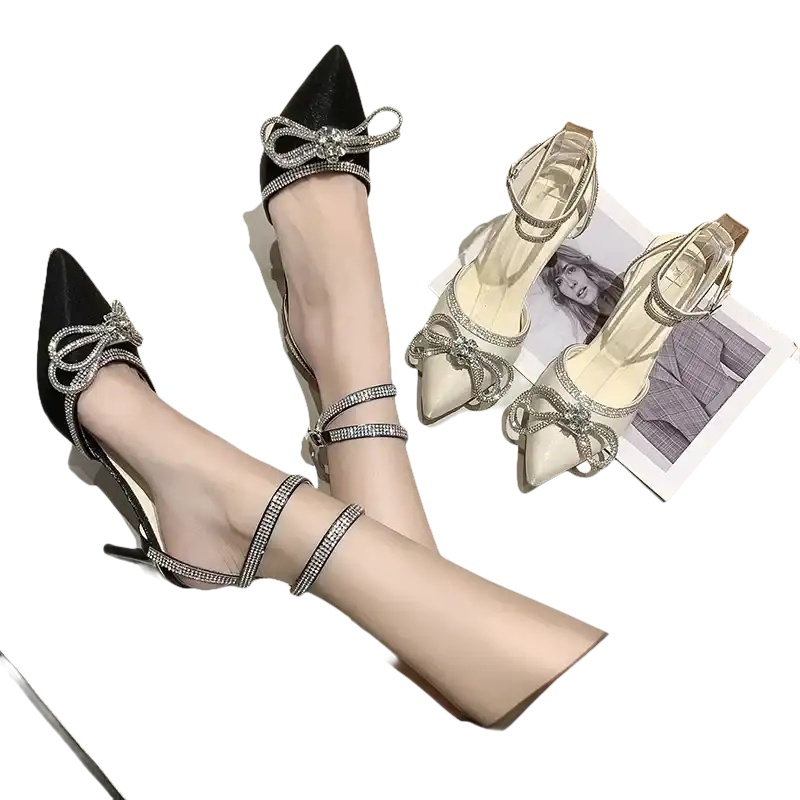 Elegant high-heeled shoes with rhinestone bows and ankle straps.