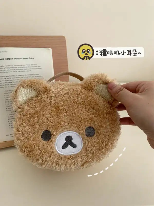 Fuzzy brown bear-shaped purse.