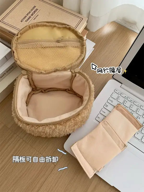 Open, fuzzy, round cosmetic bag.