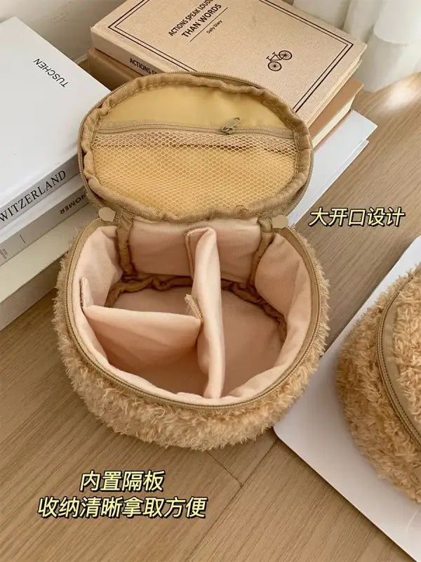 Open, fuzzy, round cosmetic bag.