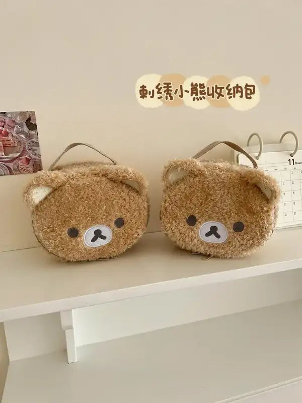 Two brown, fuzzy bear-shaped bags.