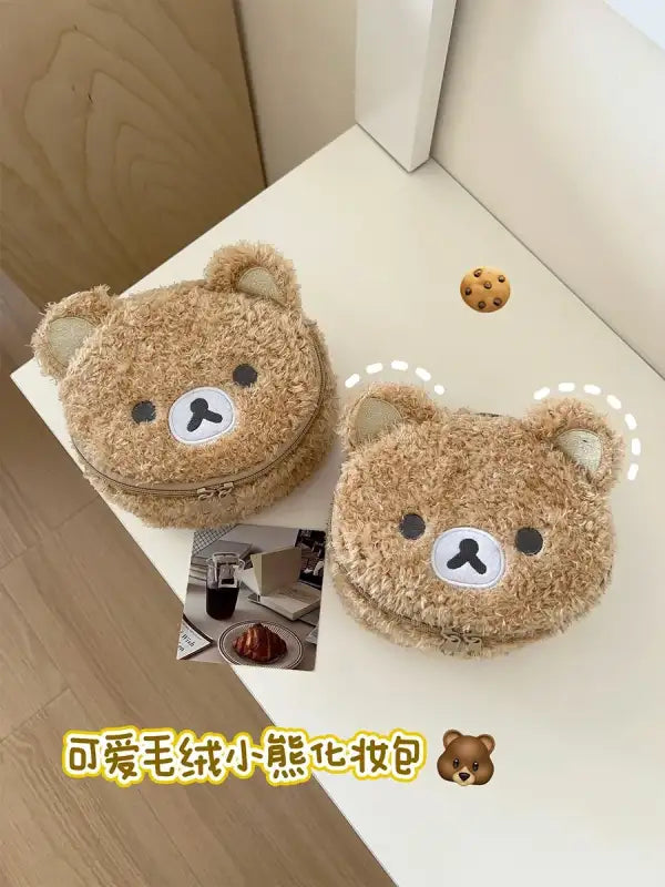 Two fuzzy bear-shaped cosmetic bags.