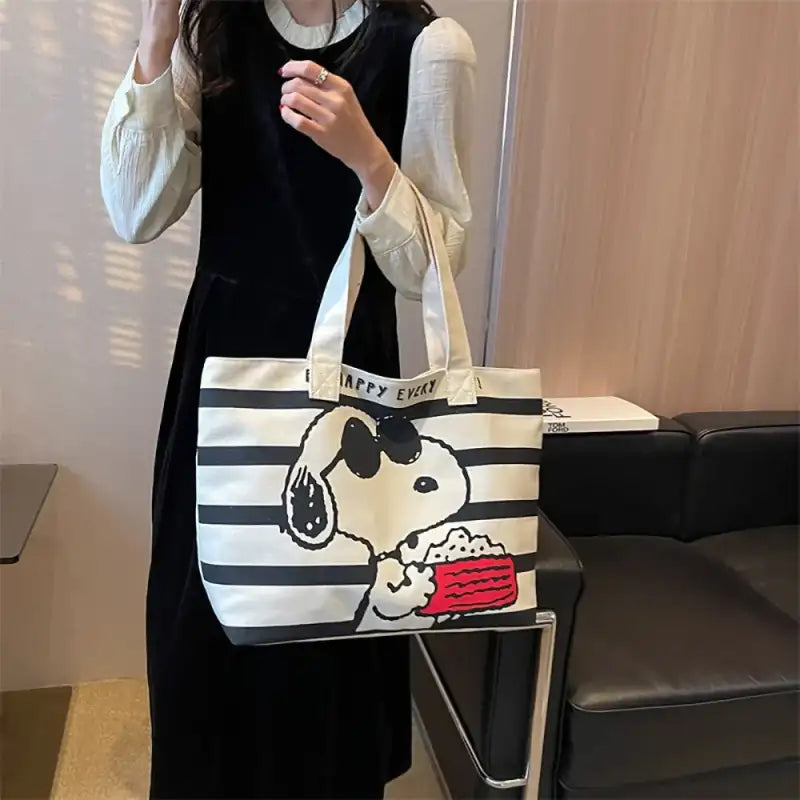 Striped tote bag with Snoopy graphic.