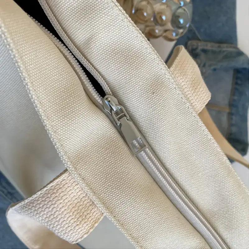 Canvas tote bag with zipper.