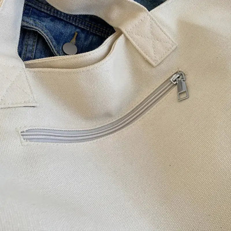 Canvas tote bag with zipper pocket.
