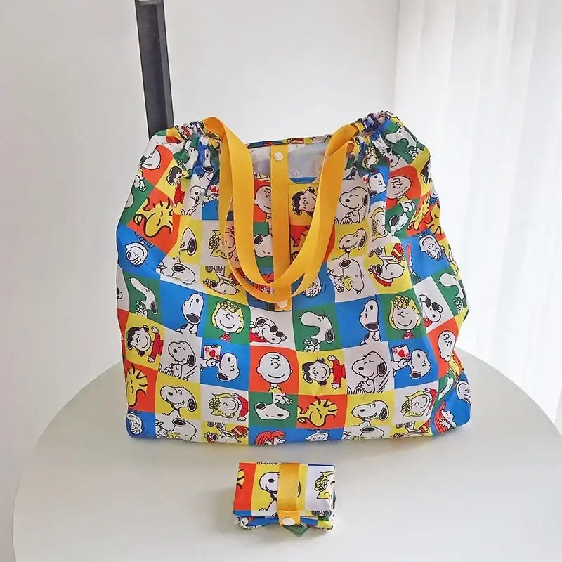Snoopy-themed reusable shopping bag with yellow straps.