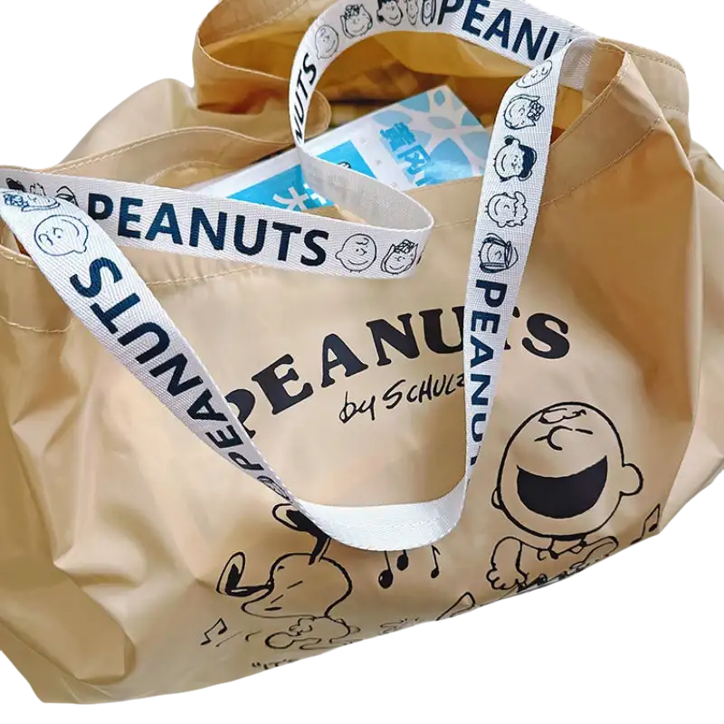 Peanuts-themed beige tote bag.