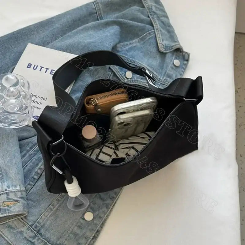 Black shoulder bag with contents.