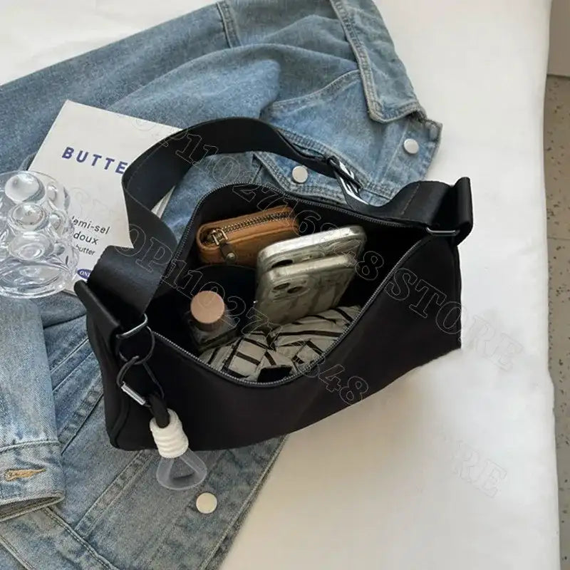 Open black shoulder bag.