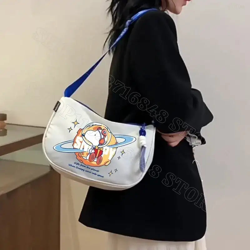 White shoulder bag with cartoon astronaut.