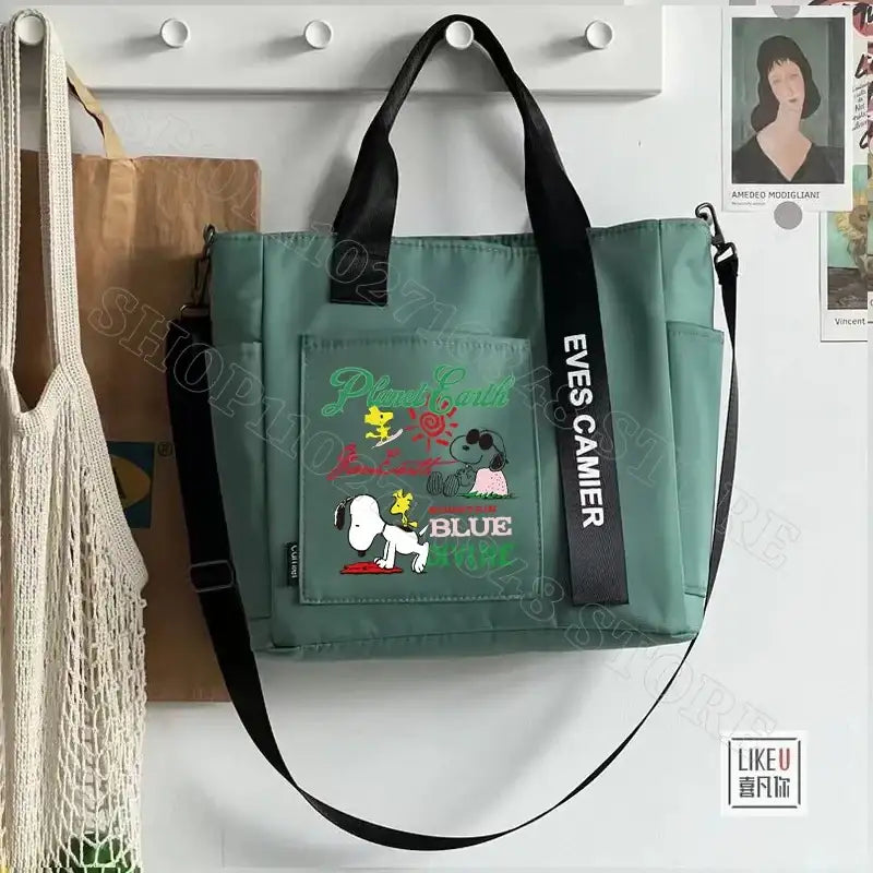 Green tote bag with Snoopy design.