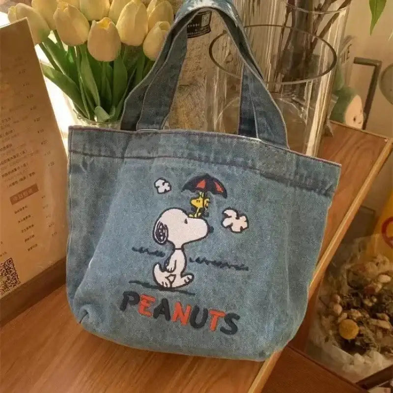 Denim tote bag with Snoopy design.