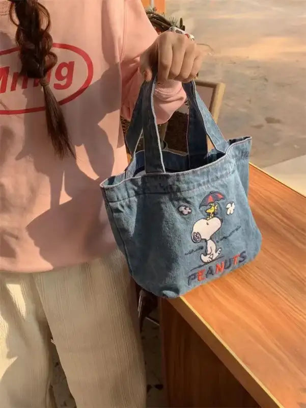Denim tote bag with Snoopy design.