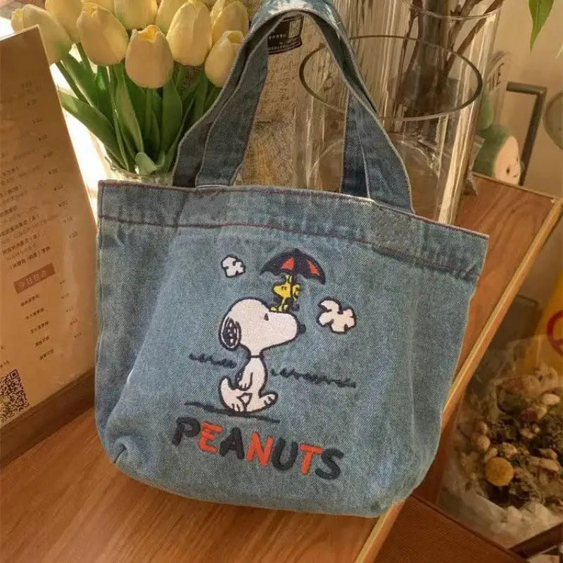 Denim tote bag with Snoopy design.