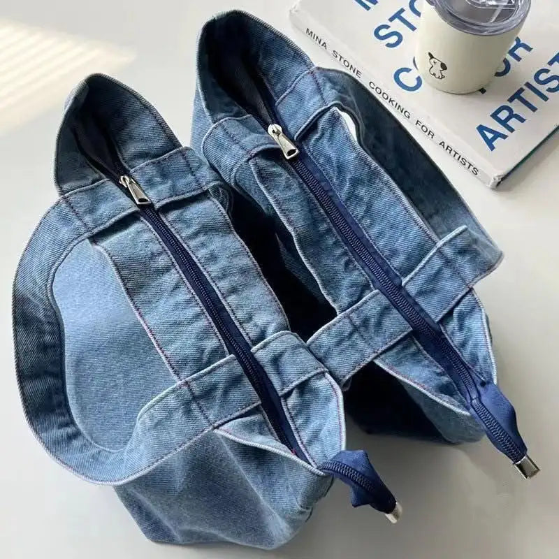 Two denim tote bags with zipper closures.