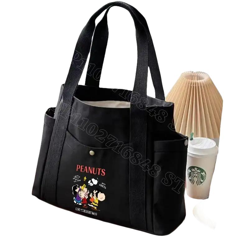 Black canvas tote bag with Peanuts characters.