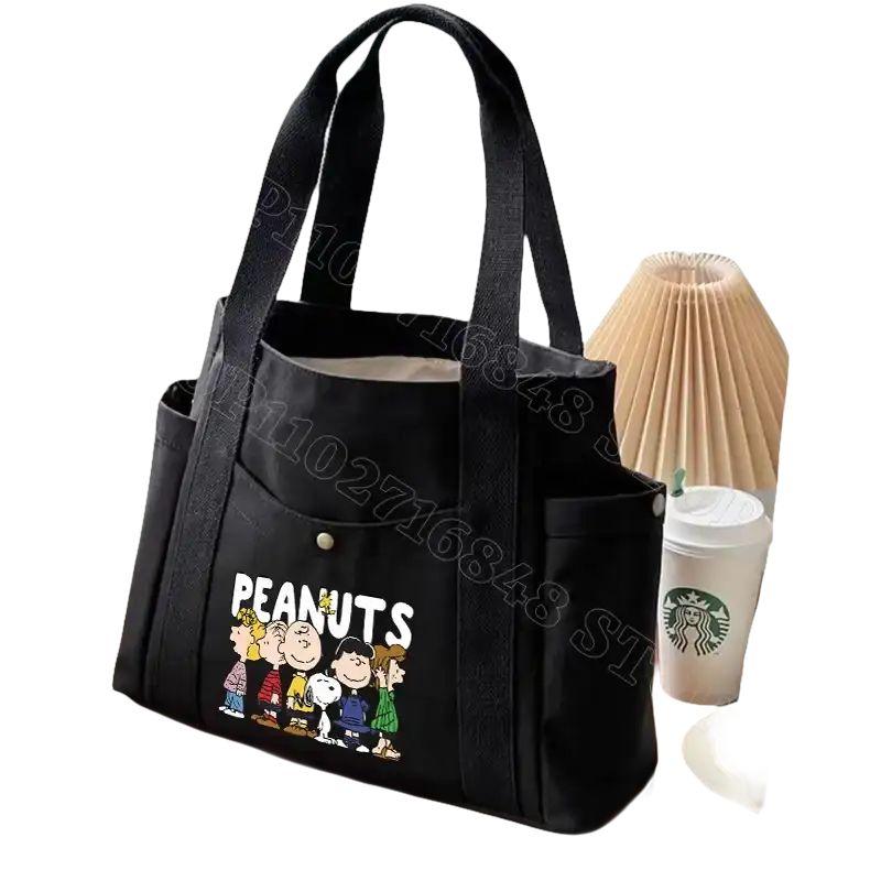 Black canvas tote bag with Peanuts characters.
