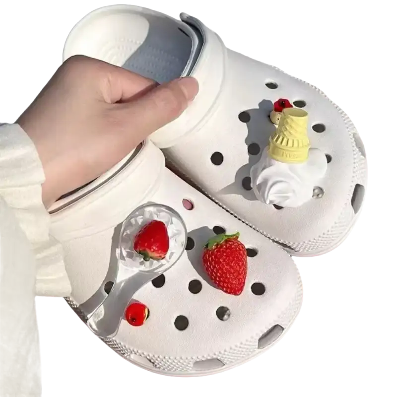 White Crocs with strawberry and ice cream charms.