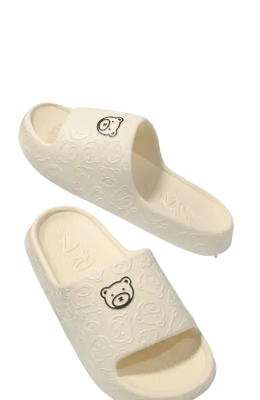 Cream-colored bear-themed platform sandals.