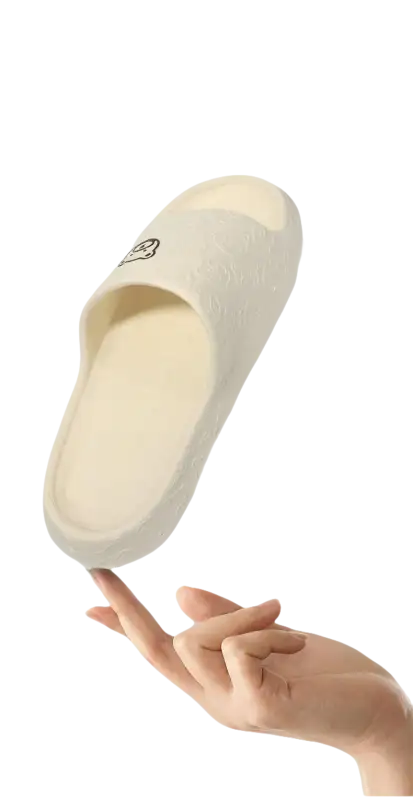 Cream-colored slipper with a cartoon face.