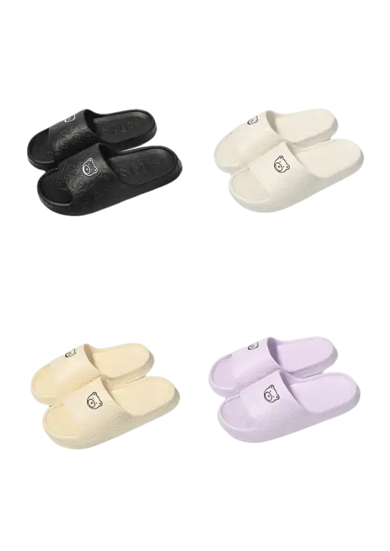 Four pairs of cartoon-emblazoned slippers.