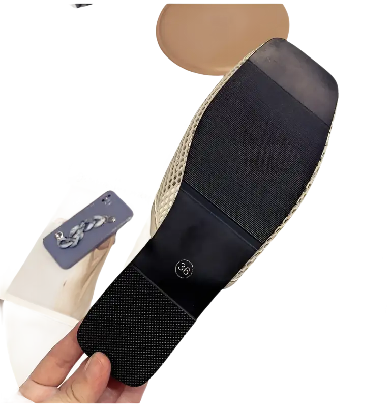 Black-soled, square-toed shoe.