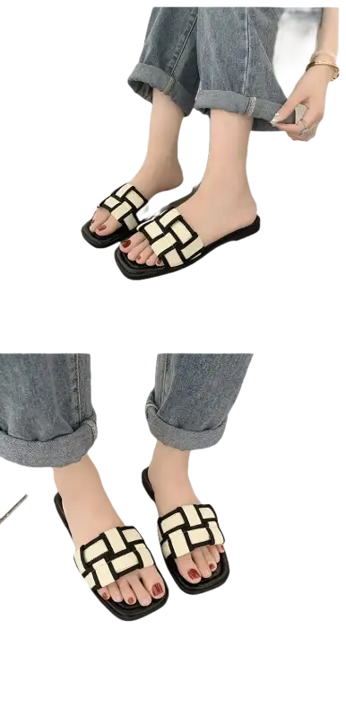 Black and white woven slide sandals.