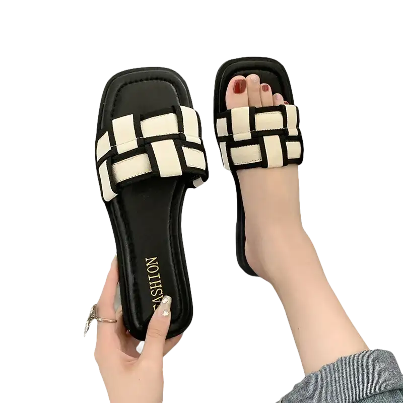 Black and white woven slide sandals.