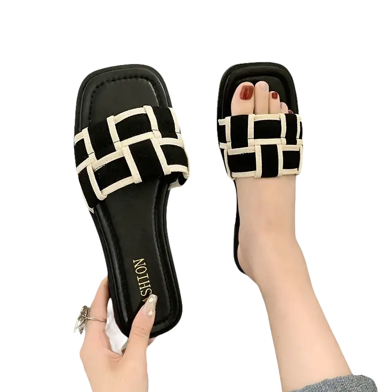 Black and white woven slide sandals.