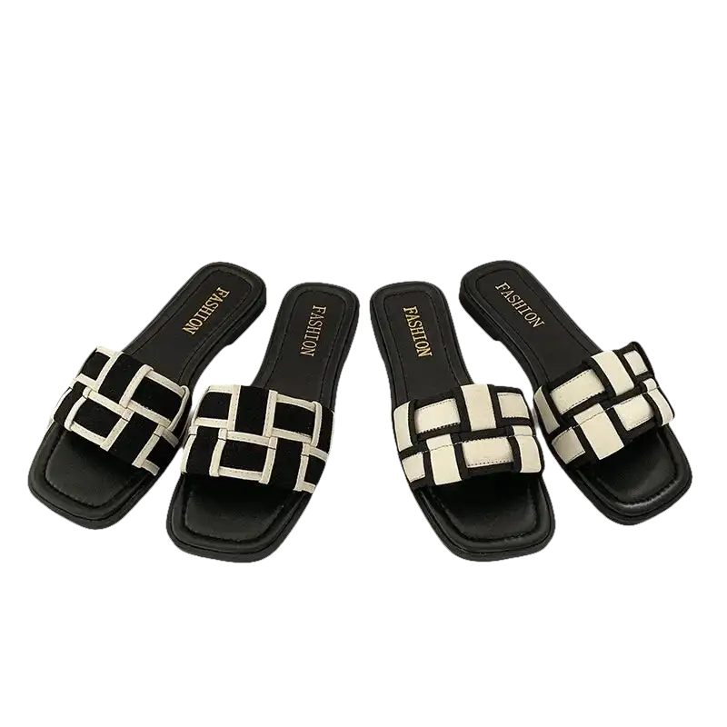 Four black and white woven slide sandals.