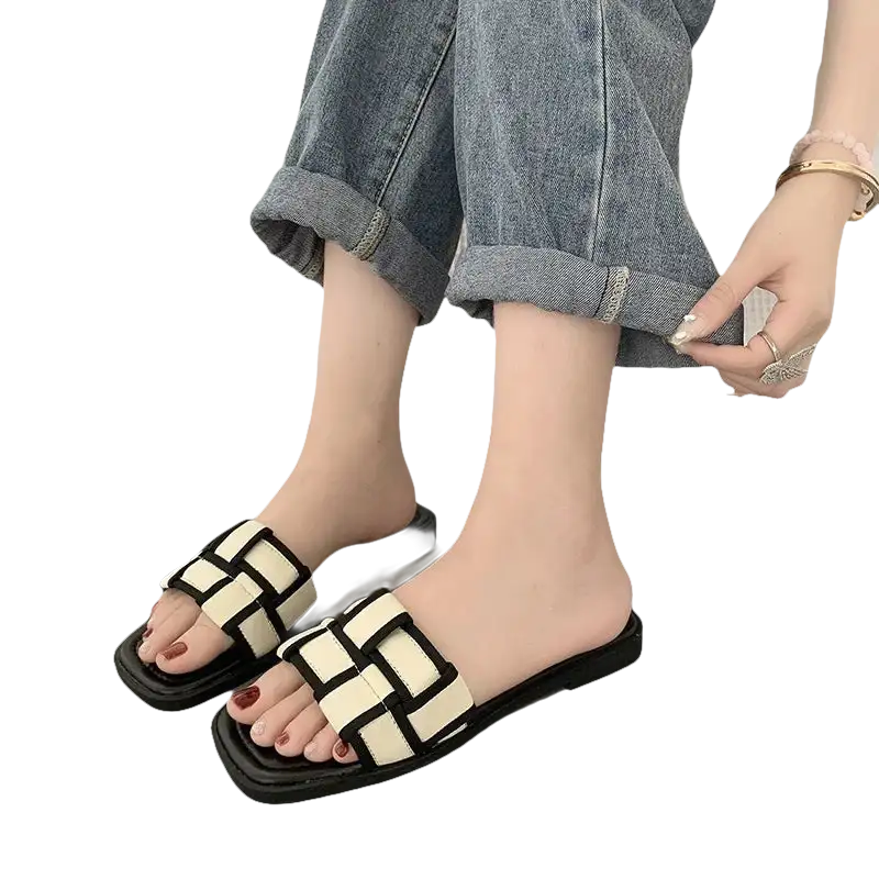 Woven black and white slide sandals.