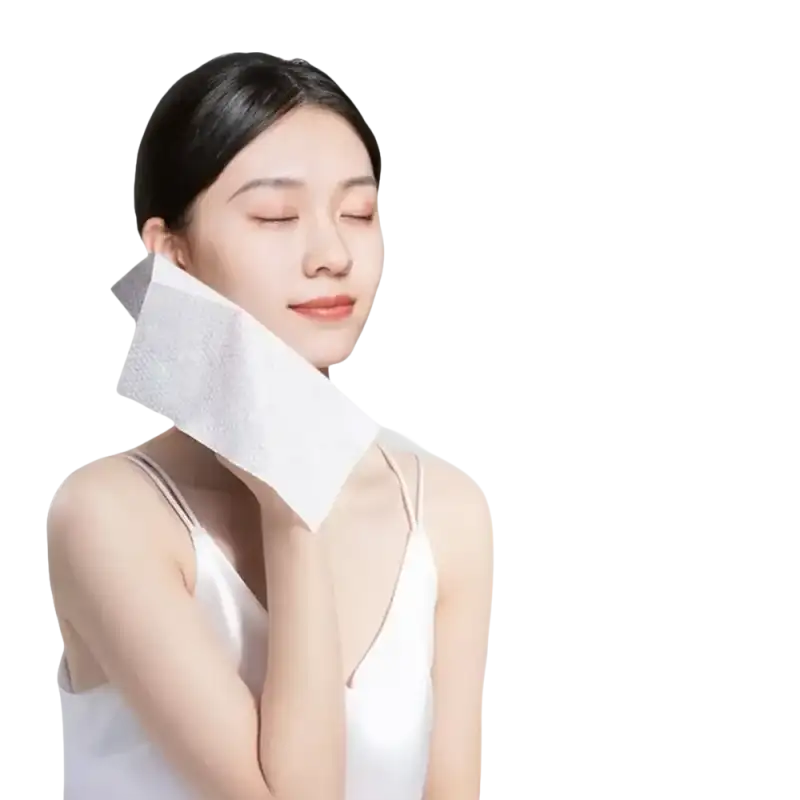 Woman holding a white facial wipe.