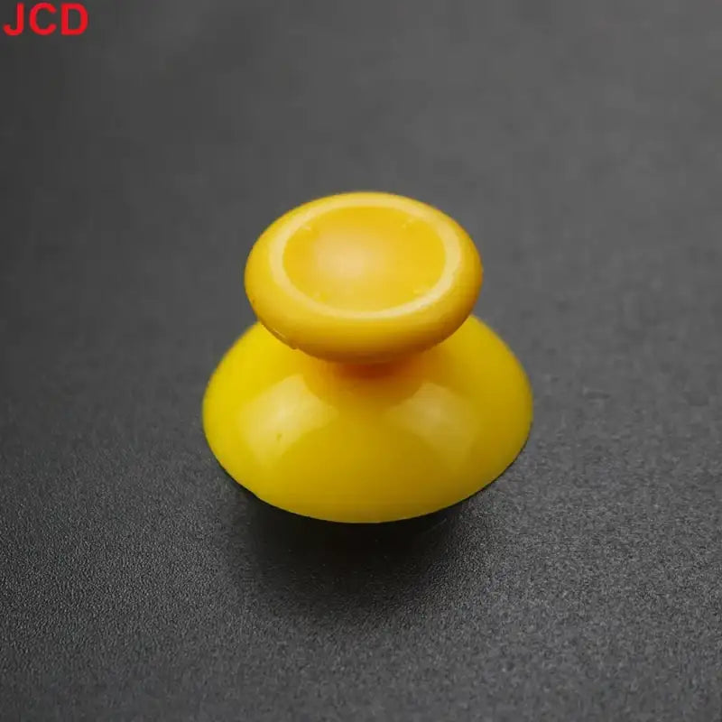 Yellow plastic joystick cap.