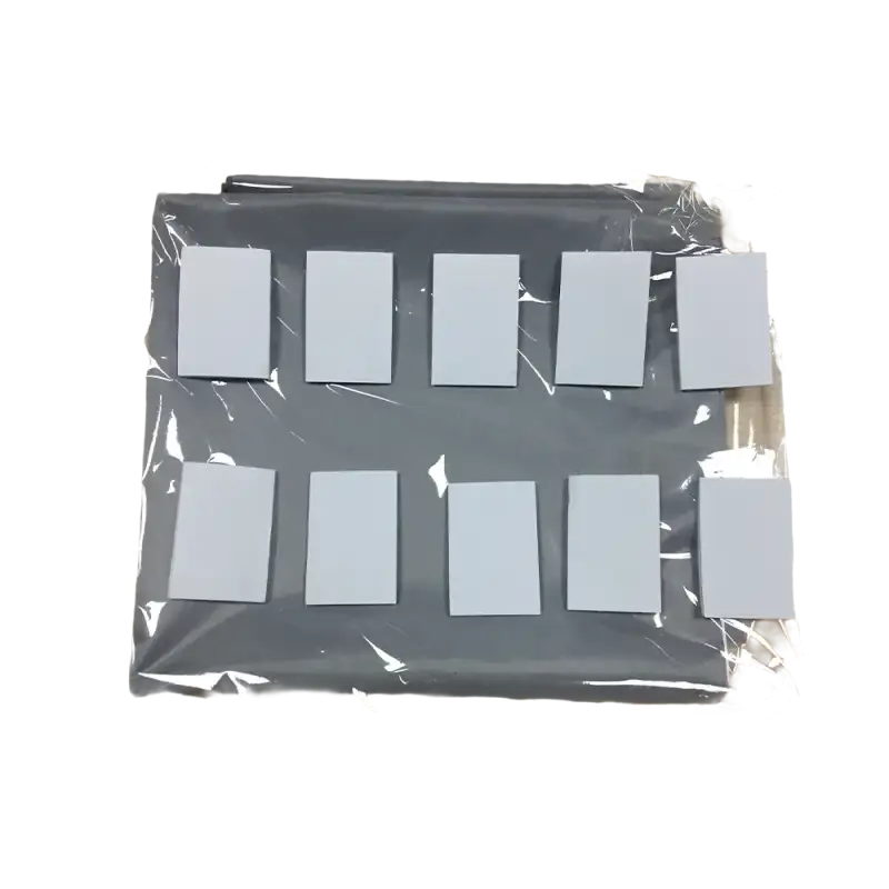 Gray organizer with white squares in plastic wrap.