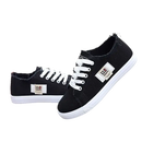 Black canvas sneakers with white laces.