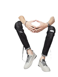 Man in black ripped jeans and gray sneakers.