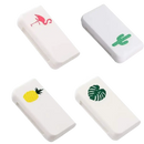 Four white, rectangular, decorated erasers.