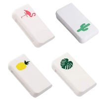 Four white, rectangular, decorated erasers.
