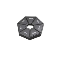 Black hexagonal pill organizer.