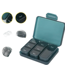 Green pill organizer with labeled compartments.