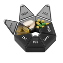 Seven-compartment pill organizer with various pills.
